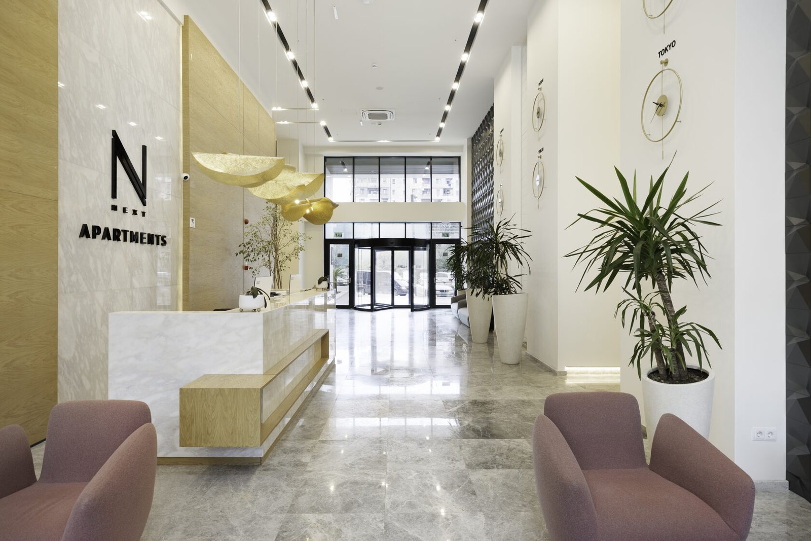 Completed NEXT Apartments reception lobby with marble finishes and lounge seating