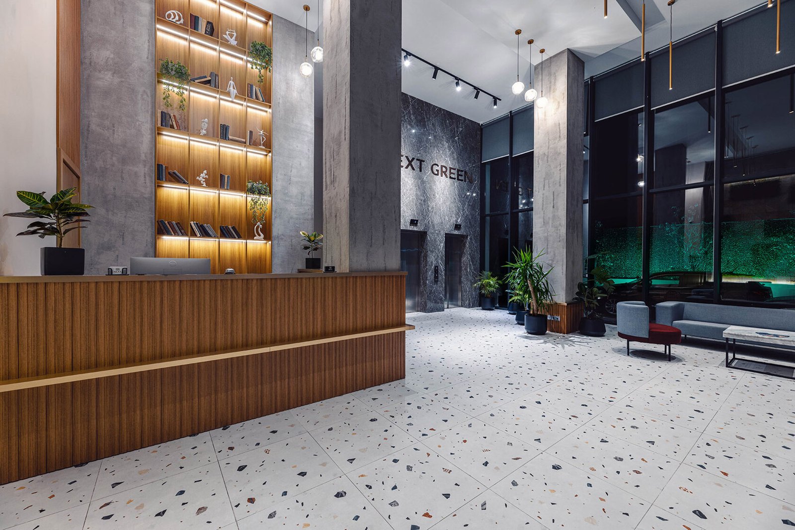 NEXT Green reception lobby with tall glazing and stone finishes